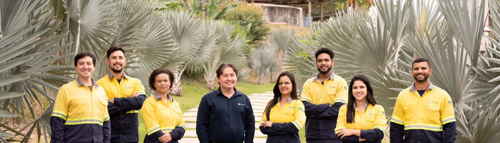 Group of PLS Brasil employees standing on a path