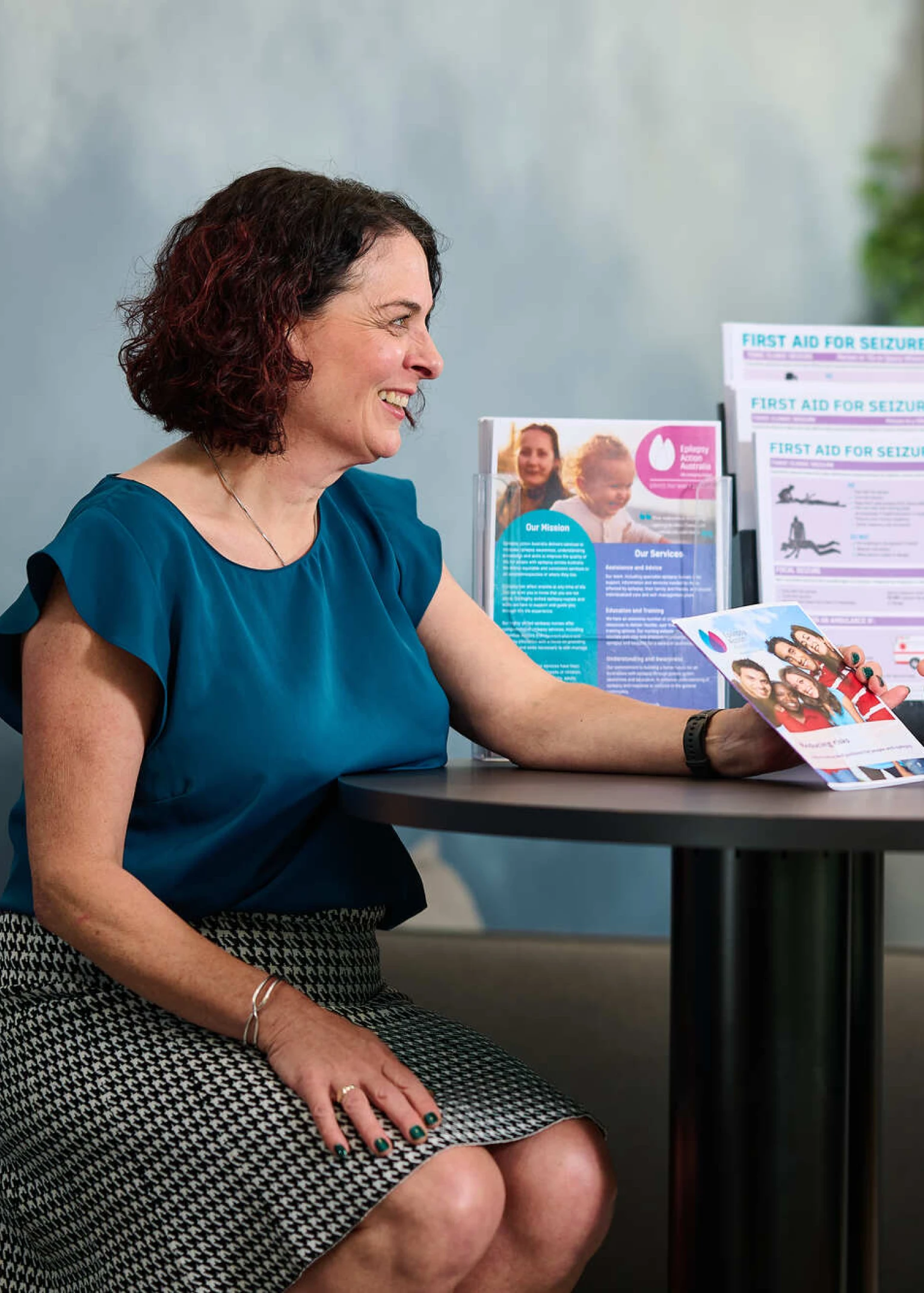 Two people sitting at table looking at brochures